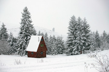 Snow covered hut in the mountains