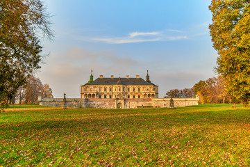 Pidhirtsi castle against fall colors and blue sky.