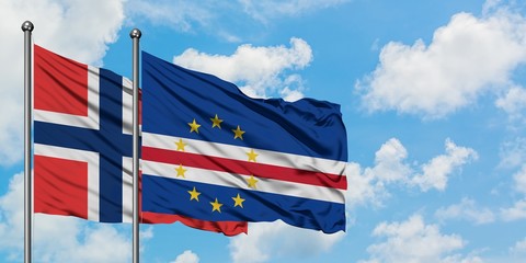 Norway and Cape Verde flag waving in the wind against white cloudy blue sky together. Diplomacy...