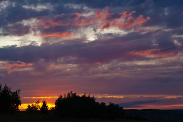 Beautiful colorful sunset over field. Nature landscape sunset background