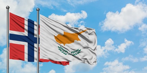Norway and Cyprus flag waving in the wind against white cloudy blue sky together. Diplomacy concept, international relations.