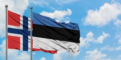 Norway and Estonia flag waving in the wind against white cloudy blue sky together. Diplomacy concept, international relations.