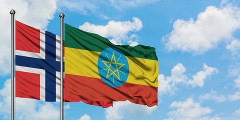 Norway and Ethiopia flag waving in the wind against white cloudy blue sky together. Diplomacy concept, international relations.