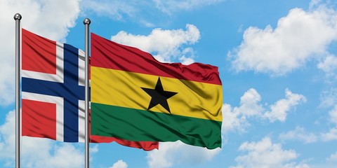 Norway and Ghana flag waving in the wind against white cloudy blue sky together. Diplomacy concept,...