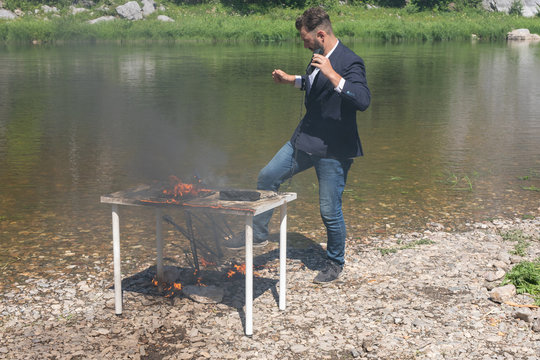 office worker hates his job. And burned the office in a fit of rage. young bearded guy, hipster in jacket overworked.