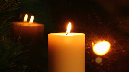 Amber candle flame reflected in the glass, romantic appointment