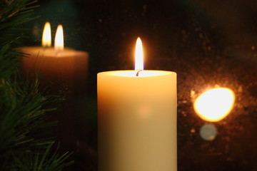 Romantic candle flame reflected in the glass, the Christmas mood