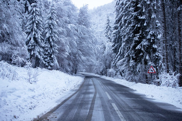 Empty road with snow banks on sides.