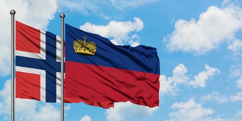 Norway and Liechtenstein flag waving in the wind against white cloudy blue sky together. Diplomacy...