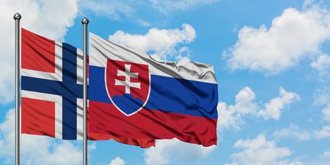 Norway and Slovakia flag waving in the wind against white cloudy blue sky together. Diplomacy concept, international relations.