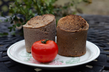 Buckwheat bread with tomatoes on white background