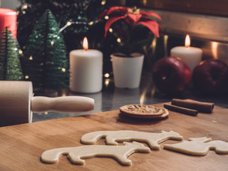 Christmas shapes on cookies dough. Home Pastry preparation on Christmas time. traditional christmas cookies with cinnamon and spice. Rolling pin, candles and christmas trees on background 6