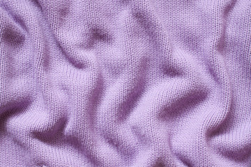 Fototapeta na wymiar Knit stitch pattern, soft purple color woolen clothes, knitted fabric texture