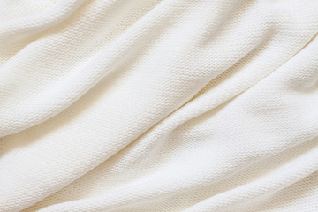 Knitted fabric background, purl stitch pattern, soft white woolen clothes