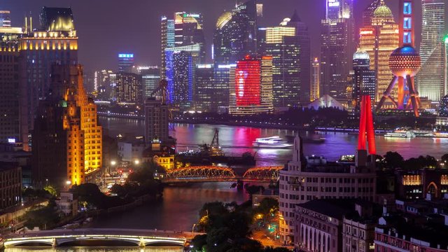 Timelapse Shanghai highrise buildings with bright advertisement illumination surround Waibaidu Bridge at Suzhou Creek in China at night