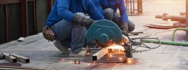 Close up view of professional focused two worker man in uniform working on the metal pipe © sutlafk