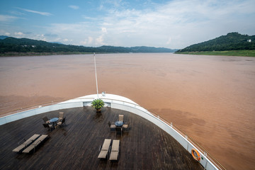 Front of a cruise ship on muddy Yangtze river during summertime China