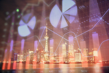 Financial graph on night city scape with tall buildings background multi exposure. Analysis concept.