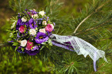 close up of wedding bouquet by wooden fence
