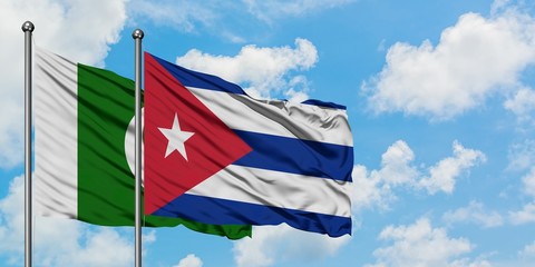 Pakistan and Cuba flag waving in the wind against white cloudy blue sky together. Diplomacy...