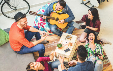 Trendy friends having fun in hostel at party night - Happy travel people enjoying time together...
