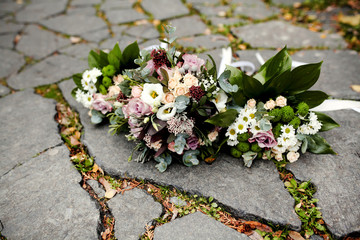 close up of wedding bouquet by wooden fence