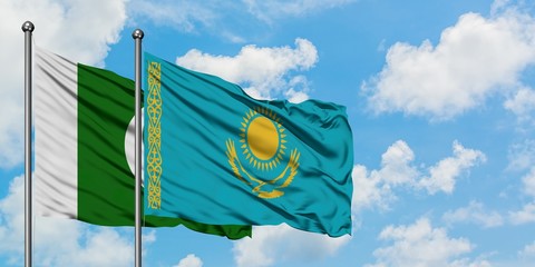 Pakistan and Kazakhstan flag waving in the wind against white cloudy blue sky together. Diplomacy...