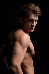 Fototapeta premium handsome shirtless man posing isolated on black