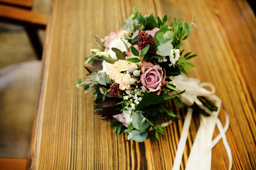 close up of wedding bouquet by wooden fence