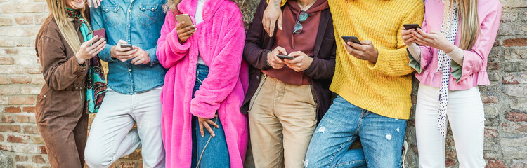 Trendy influencers friends using smartphones  - Millennials generation addiction to new technology trends - Concept of youth, commute, tech, social and friendship - Focus on hands