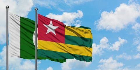 Pakistan and Togo flag waving in the wind against white cloudy blue sky together. Diplomacy concept, international relations.