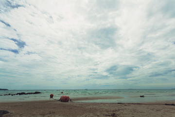 Fototapeta na wymiar Beautiful turquoise sea, sky with clouds, white line beach, natural tourism concept