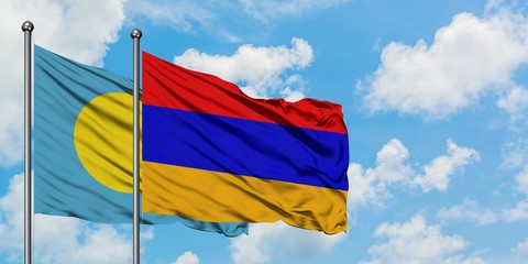 Palau and Armenia flag waving in the wind against white cloudy blue sky together. Diplomacy...