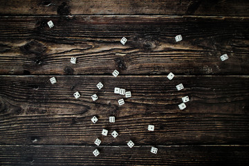 many of white dice on a wooden table