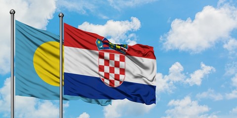 Palau and Croatia flag waving in the wind against white cloudy blue sky together. Diplomacy...