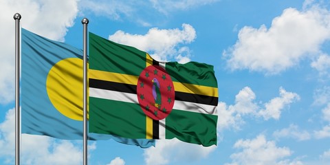 Palau and Dominica flag waving in the wind against white cloudy blue sky together. Diplomacy concept, international relations.