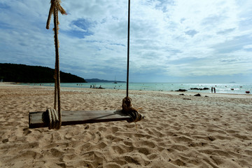  swings on sea and mountain backgrounds turquoise blue sky white clouds (concept travel holiday)