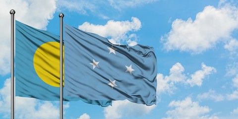 Palau and Micronesia flag waving in the wind against white cloudy blue sky together. Diplomacy concept, international relations.