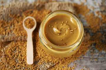 Natural mustard in a jar. Grains of mustard. Homemade mustard. Organic mustard. Selective focus. Macro.