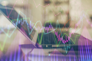 Forex graph hologram on table with computer background. Double exposure. Concept of financial markets.