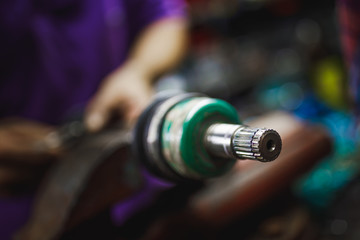 Fototapeta premium ATV constant-velocity CV joint repair in old garage