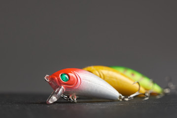 One fishing lure Wobbler closeup on the background of the other two in blur.