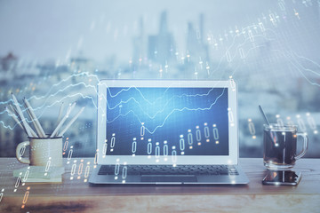 Stock market graph on background with desk and personal computer. Double exposure. Concept of financial analysis.