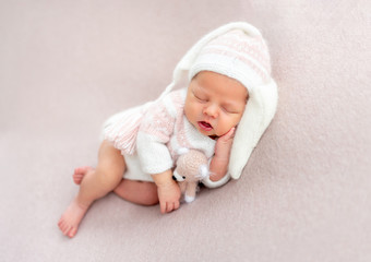 Cute newborn slepping with toy