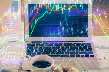 Forex market chart hologram and personal computer background. Multi exposure. Concept of investment.