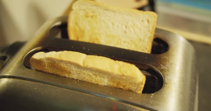 Slow motion shot of toast jumping out of an old toaster