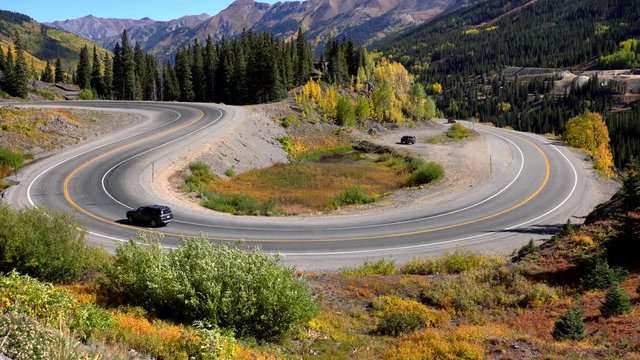 Aerial view of cars travelling on a curvy section of the Million Dollar Highway in the San Juan Mountains of Colorado