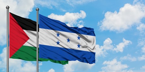 Palestine and Honduras flag waving in the wind against white cloudy blue sky together. Diplomacy...