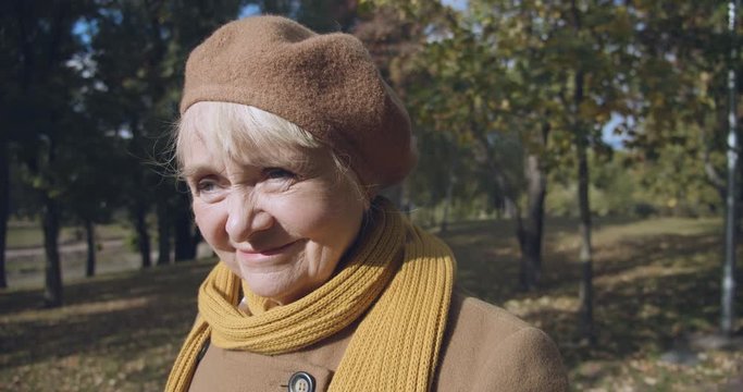 Strange senior woman wandering in park, memory loss, Alzheimers disease symptoms