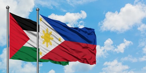 Palestine and Philippines flag waving in the wind against white cloudy blue sky together. Diplomacy...